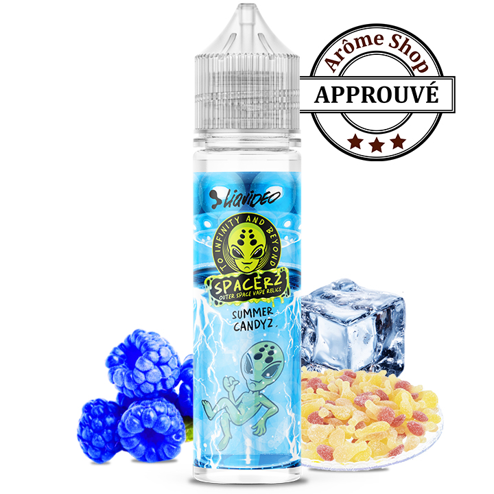 E-liquid bottle with a blue space-themed label and alien graphic, surrounded by blue raspberries, a ice cube, and colorful candy pieces, plus an 'APPROUVÉ' seal in the background. SUMMER CANDYZ BONBON SPACERZ by LIQUIDEO 💨